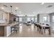 Beautiful open floor plan with light wood floors connecting living, dining, and kitchen areas at 734 E Doral Ave # 202, Gilbert, AZ 85297