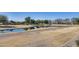 Scenic pond view surrounded by grassy areas and mature trees in a well-maintained community at 734 E Doral Ave # 202, Gilbert, AZ 85297