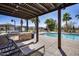 Beautiful community pool area featuring a grill, lounge chairs, and palm trees for a relaxing experience at 734 E Doral Ave # 202, Gilbert, AZ 85297