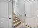 Bright interior staircase with wooden steps, white railing, and modern doors at 734 E Doral Ave # 202, Gilbert, AZ 85297