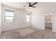 Spacious bedroom with plush carpet, ample natural light, and an en-suite bathroom at 7456 N 126Th Ln, Glendale, AZ 85307