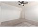 Neutral bedroom featuring carpet, ample space, and a ceiling fan at 7456 N 126Th Ln, Glendale, AZ 85307