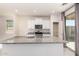 Modern kitchen with white cabinetry, granite countertops, a center island, and stainless steel appliances at 7456 N 126Th Ln, Glendale, AZ 85307