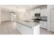 Open kitchen featuring a center island, granite countertops, and modern appliances at 7456 N 126Th Ln, Glendale, AZ 85307