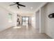Open-concept living area with tile flooring, ceiling fan, and seamless flow to the kitchen at 7456 N 126Th Ln, Glendale, AZ 85307