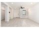 Bright and open living room with neutral tile flooring, a ceiling fan, and natural light at 7456 N 126Th Ln, Glendale, AZ 85307