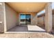 Covered patio with concrete floor and sliding glass door, perfect for outdoor relaxation and entertaining at 7456 N 126Th Ln, Glendale, AZ 85307