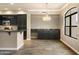 Dining area featuring stylish lighting, granite countertops, dark cabinetry, and tile flooring at 7601 E Indian Bend Rd # 2056, Scottsdale, AZ 85250