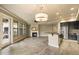 Open living room with tile floors, a ceiling fan, a fireplace, and an adjacent kitchen space at 7601 E Indian Bend Rd # 2056, Scottsdale, AZ 85250