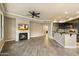 Open concept living room features tile flooring, a ceiling fan, and a modern fireplace at 7601 E Indian Bend Rd # 2056, Scottsdale, AZ 85250