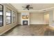 Spacious living room boasts a cozy fireplace, mounted television, and modern ceiling fan at 7601 E Indian Bend Rd # 2056, Scottsdale, AZ 85250