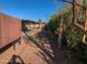Landscaped backyard with gravel and tall trees at 8640 S 16Th Pl, Phoenix, AZ 85042