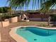 Backyard with desert landscaping, complete with a pool, covered patio and custom outdoor oven at 8640 S 16Th Pl, Phoenix, AZ 85042