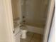 This bathroom has a standard white tub-shower combo and a toilet and sink, with tile flooring at 8640 S 16Th Pl, Phoenix, AZ 85042