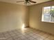 Bright bedroom with tile flooring and a window offering outdoor views at 8640 S 16Th Pl, Phoenix, AZ 85042