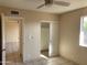 Bedroom featuring neutral walls, a ceiling fan, and closet with sliding door at 8640 S 16Th Pl, Phoenix, AZ 85042