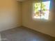 Cozy bedroom with neutral tile floors and ample natural light creating a serene and inviting atmosphere at 8640 S 16Th Pl, Phoenix, AZ 85042