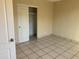 Cozy bedroom featuring tile floor, closet, and neutral color palette at 8640 S 16Th Pl, Phoenix, AZ 85042