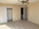 Neutral bedroom with tile flooring, a closet, and an attached bathroom for comfort and convenience at 8640 S 16Th Pl, Phoenix, AZ 85042