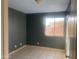 A bedroom painted in a dark-colored paint with tile flooring, a window, and great natural light at 8640 S 16Th Pl, Phoenix, AZ 85042