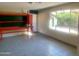 Versatile bonus room with built-in shelving, tiled floor, and natural light perfect for customization at 8640 S 16Th Pl, Phoenix, AZ 85042
