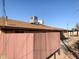 Exterior rear view of home, including rooftop AC units and gated yard at 8640 S 16Th Pl, Phoenix, AZ 85042