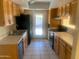 Functional kitchen with wood cabinets, stainless steel sink, and essential appliances for easy meal preparation at 8640 S 16Th Pl, Phoenix, AZ 85042