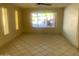 Large living area features big window, tile flooring, and neutral paint, creating a bright and inviting space at 8640 S 16Th Pl, Phoenix, AZ 85042