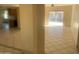 Bright and spacious living room featuring neutral tile flooring and sliding glass doors to the backyard at 8640 S 16Th Pl, Phoenix, AZ 85042