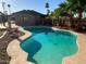 Private backyard pool, surrounded by lush desert landscaping and mature palm trees at 8640 S 16Th Pl, Phoenix, AZ 85042