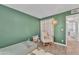 Bedroom with green walls, wood-look floors, and natural light from a window at 8760 W Meadow Dr, Peoria, AZ 85382