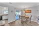Bright dining area with sliding door access to the backyard and updated chandelier at 8760 W Meadow Dr, Peoria, AZ 85382