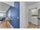Hallway featuring in-unit laundry, storage, and an entryway with a blue accent wall at 8760 W Meadow Dr, Peoria, AZ 85382