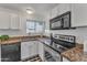 Well-maintained kitchen with granite countertops, stainless steel appliances, and white cabinetry at 8760 W Meadow Dr, Peoria, AZ 85382