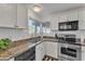 Updated kitchen with granite countertops, black appliances, and ample cabinet space at 8760 W Meadow Dr, Peoria, AZ 85382