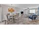 Open-concept living and dining area with wood-look floors and modern chandelier at 8760 W Meadow Dr, Peoria, AZ 85382