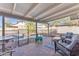 Covered patio overlooking the pool area, complete with comfortable seating and desert landscaping at 8760 W Meadow Dr, Peoria, AZ 85382