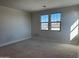 Bright bedroom with large windows showcasing neighborhood views and awaiting personalization at 10039 W Verde Ln, Avondale, AZ 85392