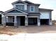 Attractive two-story home with a gray exterior, brick accents, and an attached two-car garage at 10039 W Verde Ln, Avondale, AZ 85392
