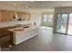 Open concept kitchen with light wood cabinetry, an island with a white countertop, and stainless steel appliances at 10039 W Verde Ln, Avondale, AZ 85392