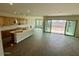 Open-concept kitchen with wood cabinets, a central island, and sliding glass doors leading to an outdoor space at 10039 W Verde Ln, Avondale, AZ 85392