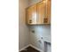 Bright laundry room with wooden cabinets providing ample storage space for household essentials at 10039 W Verde Ln, Avondale, AZ 85392