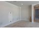 Spacious living room featuring fresh paint, ample natural light, and an arched doorway to the hallway at 10039 W Verde Ln, Avondale, AZ 85392
