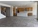 Bright living area with open layout, wooden cabinets in the kitchen, and large windows for natural light at 10039 W Verde Ln, Avondale, AZ 85392