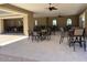 Community patio with tables, chairs, and ceiling fans for resident use at 10039 W Verde Ln, Avondale, AZ 85392