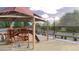 Community playground with play structures, covered picnic tables, and a large common area at 10039 W Verde Ln, Avondale, AZ 85392