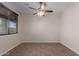 Bedroom features tile flooring, a ceiling fan and a window at 10287 S 175Th Ave, Goodyear, AZ 85338