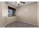 Carpeted bedroom featuring neutral paint and a window with blinds for natural light at 10287 S 175Th Ave, Goodyear, AZ 85338