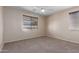 Bedroom with carpet flooring, ceiling fan and window with blinds at 10287 S 175Th Ave, Goodyear, AZ 85338
