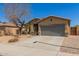 Single-story home featuring a two-car garage, desert landscaping, and a well-maintained front yard with a clear blue sky at 10287 S 175Th Ave, Goodyear, AZ 85338
